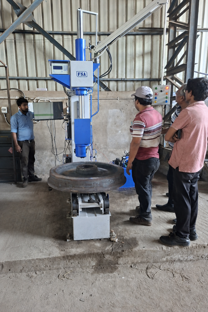 fsa deep throat brinell hardness testing machine installation texmaco type (2) Testwin engineers installing and commissioning an FSA Deep Throat Brinell Hardness Testing Machine with Roller Conveyors (TEXMACO Type) at an industrial facility.