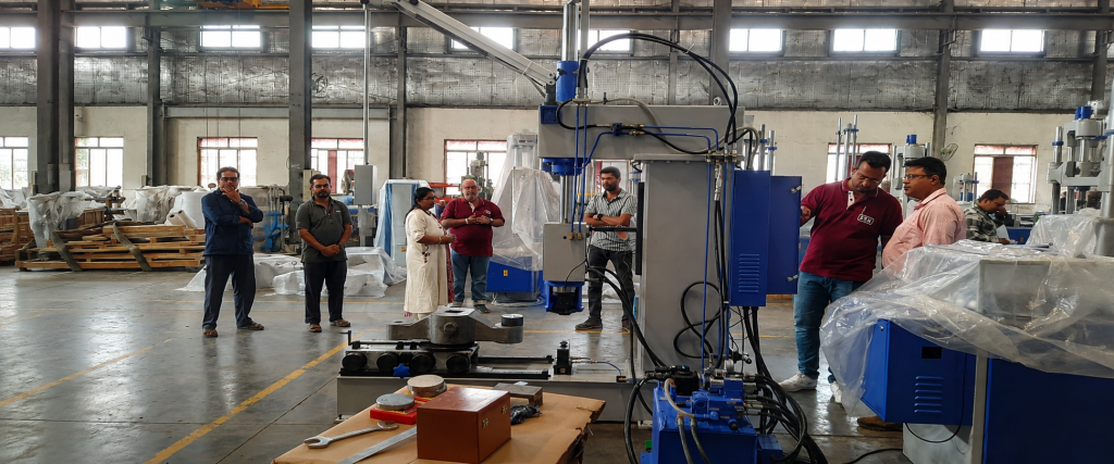 fsa factory machine inspection for indian railways testwin md engineers Managing Director of TESTWIN with FSA engineers inspecting a material testing machine at the FSA factory before delivery to Indian Railways.